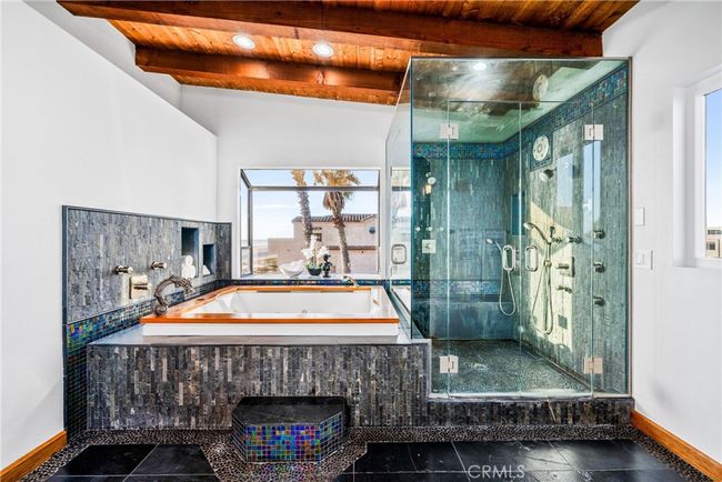 An elegant master bath with premium finishes, a steam shower, and a soaking tub that defines relaxation. | Image 42