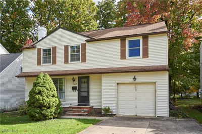 View of front of house with a front lawn and a garage | Image 1