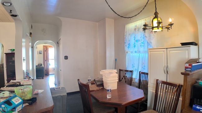 View of front of house with covered porch, brick siding, and a chimney | Image 7