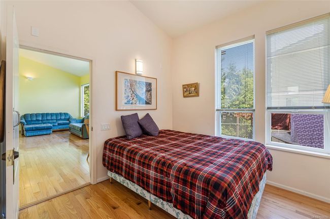 Bedroom featuring wood finished floors, baseboards, and vaulted ceiling | Image 37