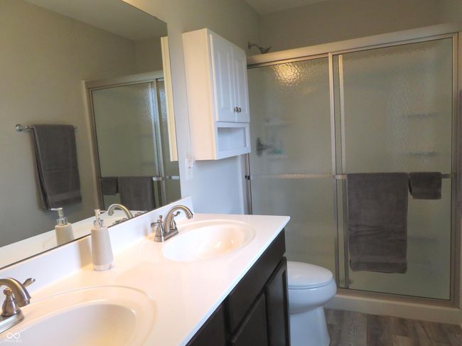 Primary bathroom with double sinks and walk in shower. | Image 31
