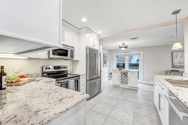 Elegant, upscale kitchen finishes, cabinetry, lighting, marble counters and more. | Image 7