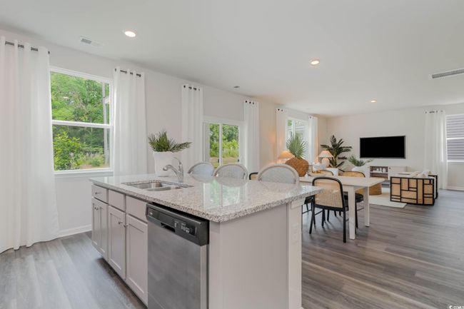Kitchen with stainless steel dishwasher, a sink, a kitchen island with sink, plenty of natural light, and recessed lighting | Image 8