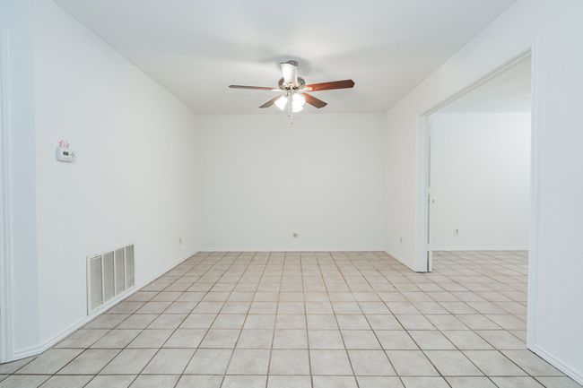 Spare room with visible vents, ceiling fan, light tile patterned flooring, and baseboards | Image 32