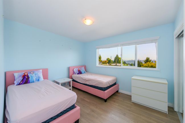 Bedroom with light wood-style floors and baseboards | Image 19