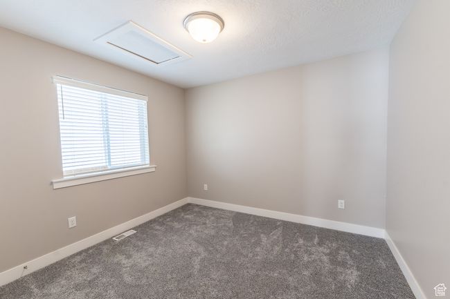 Carpeted empty room featuring attic access and baseboards | Image 12