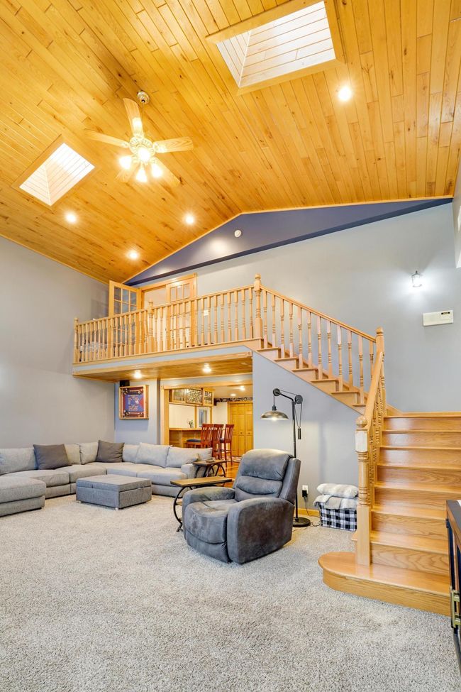 Beautiful bright skylights and gorgeous wood plank ceilings in this great space overlooking a beautiful wooded backyard. | Image 10