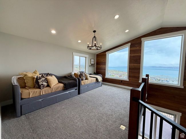 Loft area featuring wooden walls, an inviting chandelier, carpet floors, recessed lighting, and vaulted ceiling | Image 29