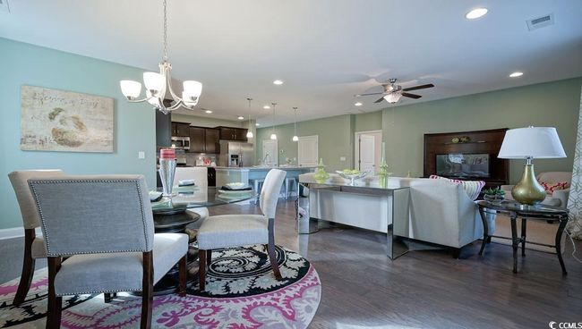 Dining area with a ceiling fan, recessed lighting, dark wood finished floors, and a chandelier | Image 16