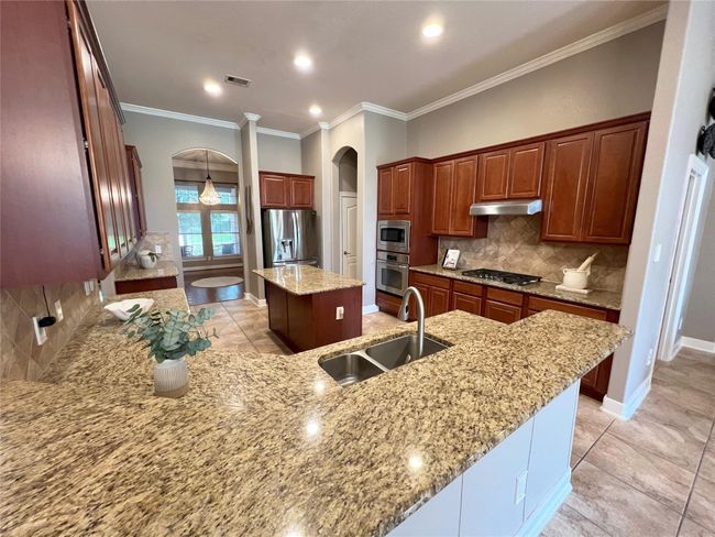 Kitchen opens to living room. Granite countertops with large island. Great for entertaining. | Image 8