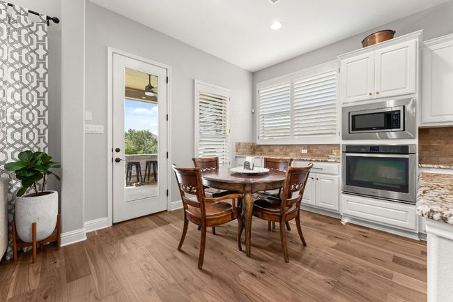 Eat in kitchen with a door that leads to the covered patio. | Image 8