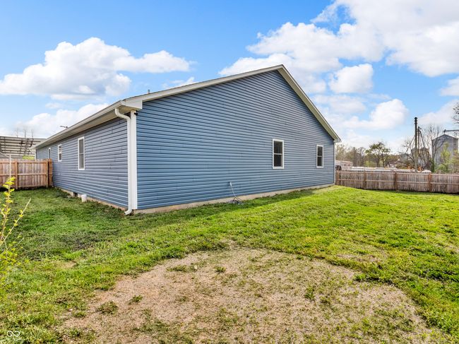 view of property exterior featuring a yard and a fenced backyard | Image 26
