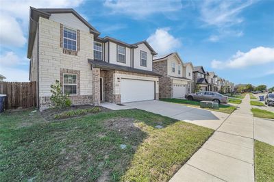 View of front of property featuring a front yard and a garage | Image 2