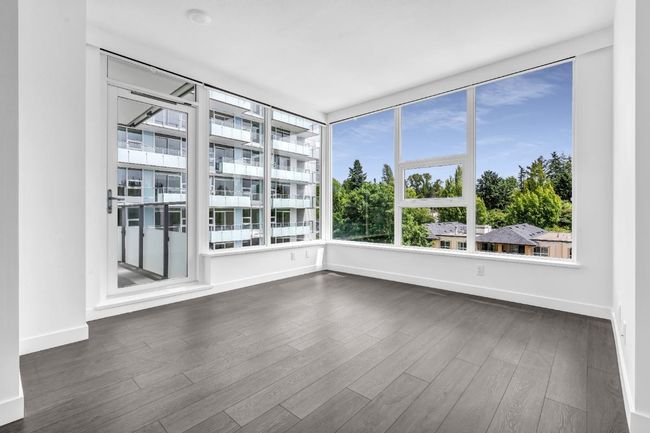 Unfurnished room featuring dark wood-type flooring and a smoke detector | Image 8