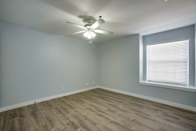 Unfurnished room with wood finished floors and a ceiling fan | Image 11