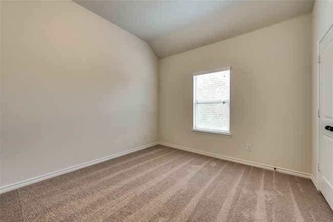 Carpeted empty room with baseboards and vaulted ceiling | Image 5