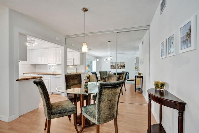 Dining Area with slider mirrors that provide plenty of storage. | Image 11