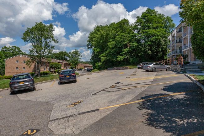 View of parking are in front of building with curbs | Image 21