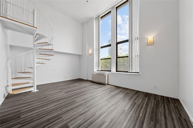 Unfurnished living room with stairway, wood finished floors, and baseboards | Image 14