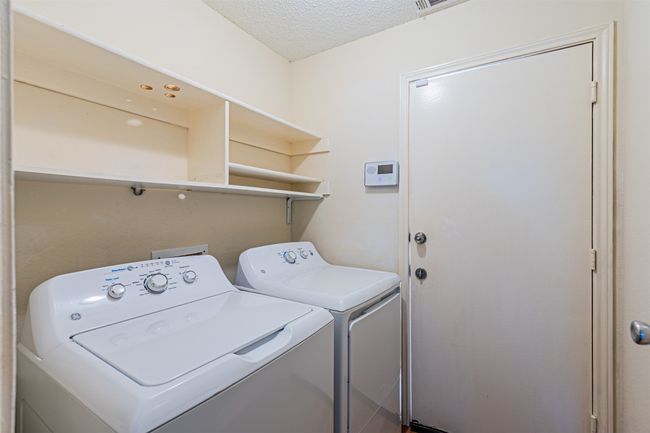 Laundry room with independent washer and dryer and a textured ceiling | Image 15