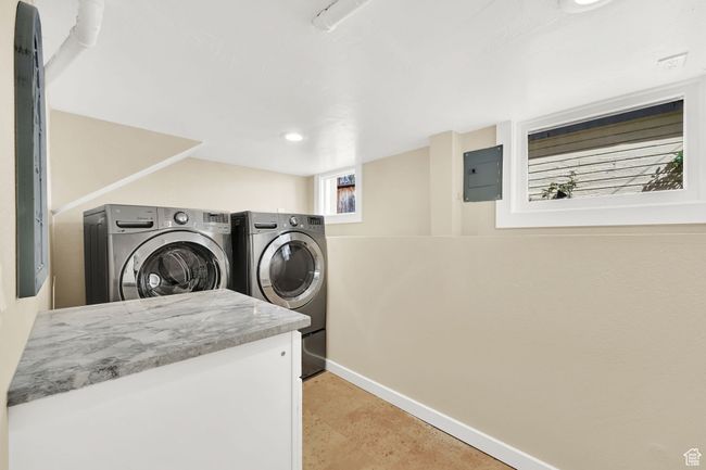 Clothes washing area featuring washing machine and dryer, baseboards, recessed lighting, and laundry area | Image 24