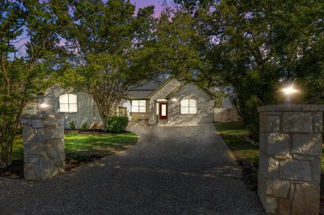 This home boasts impressive curb appeal both day and night. | Image 6