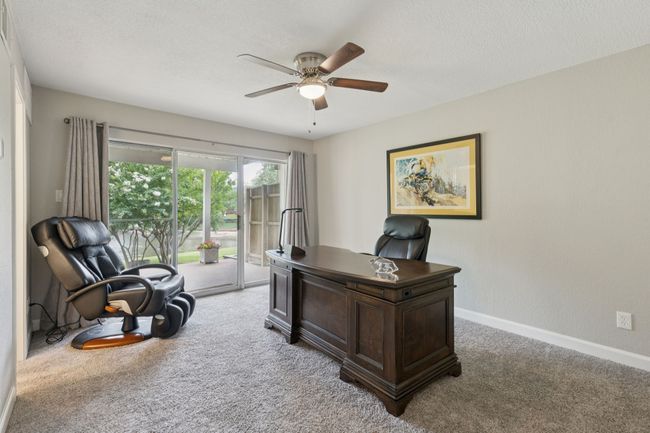 Office with carpet flooring, ceiling fan, baseboards, and a textured ceiling | Image 5