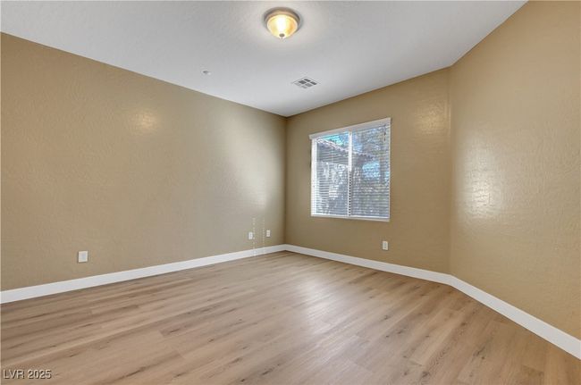 Master bedroom with baseboards, visible vents, and a textured wall | Image 14