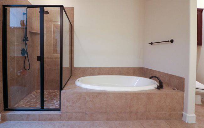 Full bathroom with a shower stall, a bath, and toilet | Image 20