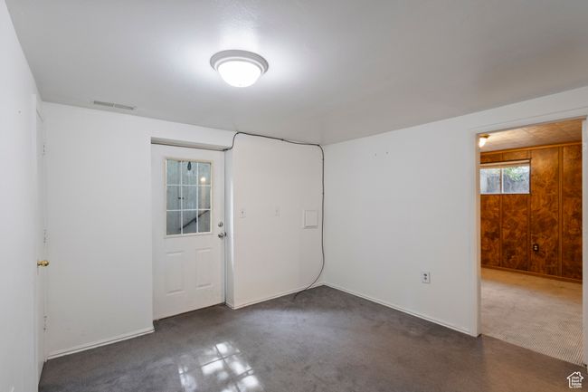Unfurnished room featuring baseboards and wooden walls | Image 27
