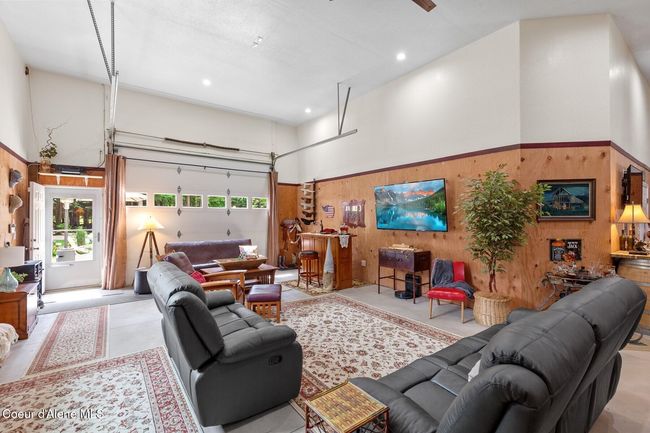 Family Area looking towards front man door and 12x10 Overhead Door with curtains open | Image 6