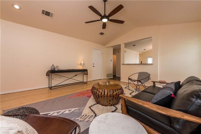 Living room featuring a ceiling fan, lofted ceiling, and wood finished floors | Image 18
