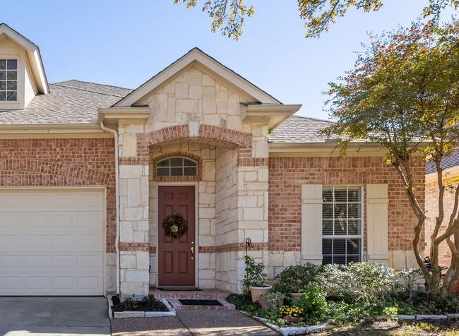 Doorway to property with a garage | Image 4