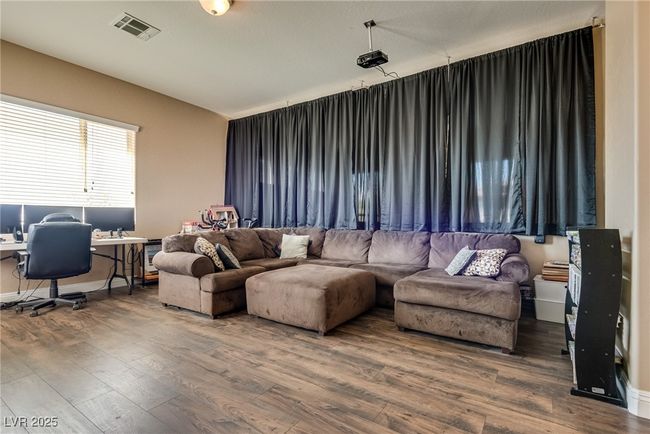 Living room featuring wood finished floors, baseboards, and visible vents | Image 35