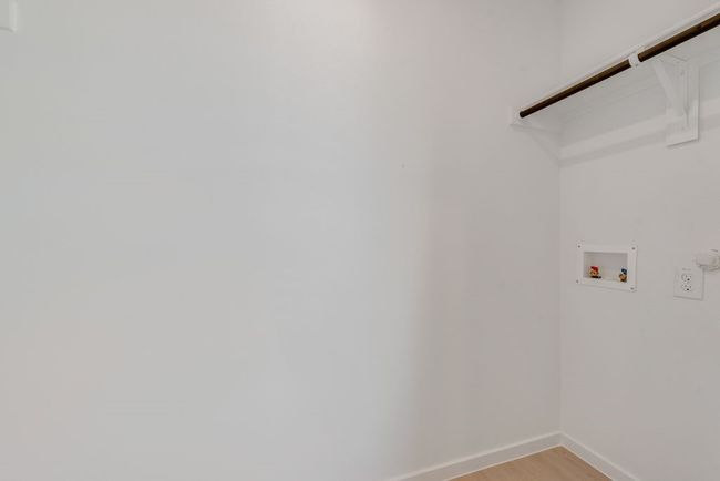 Washroom featuring light wood finished floors and hookup for a washing machine | Image 14