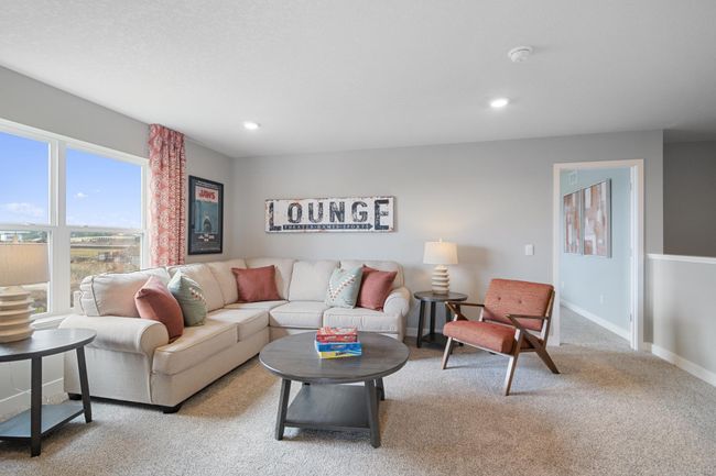 Relax, play and enjoy! This upper-level game room provides an additional 270 square feet of living space and is conveniently located adjacent to all four upper-level bedrooms. Model photo. Options and colors will vary. | Image 15