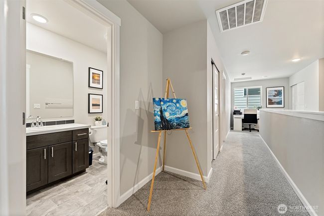 Upstairs hallway with view into full bath. | Image 23
