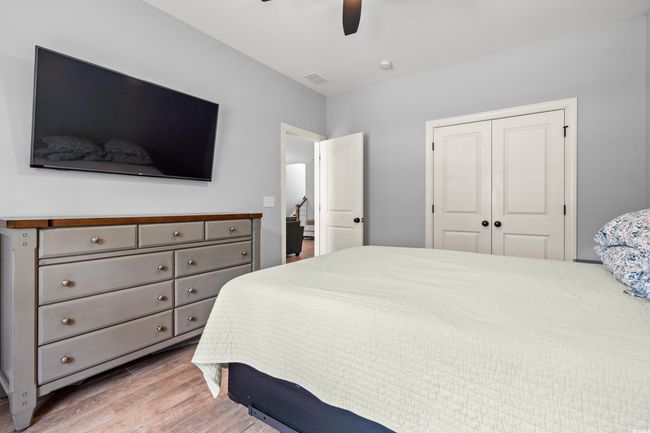 Bedroom with wood finished floors, a closet, and ceiling fan | Image 16