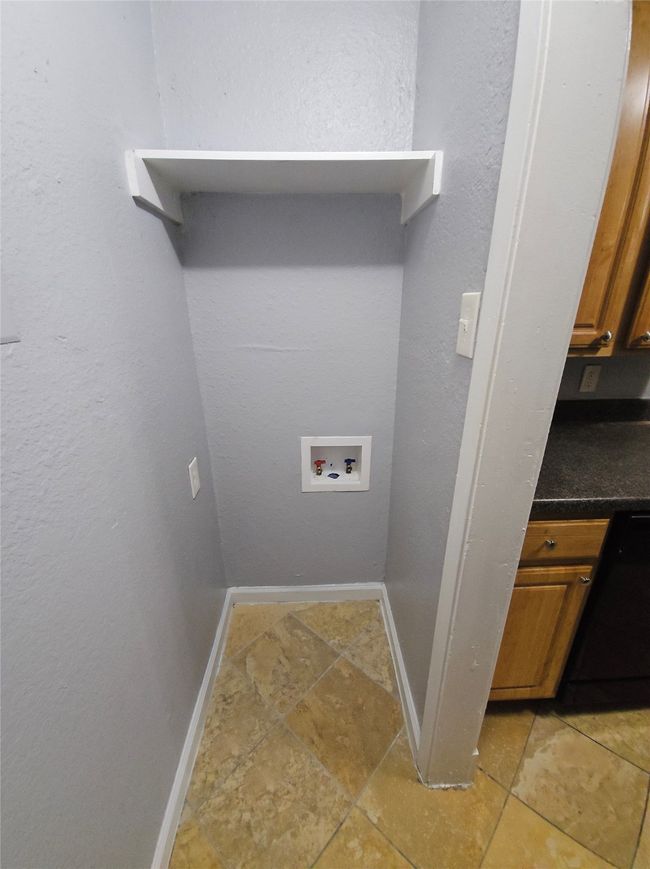 Laundry room featuring washer hookup and light tile patterned floors | Image 10