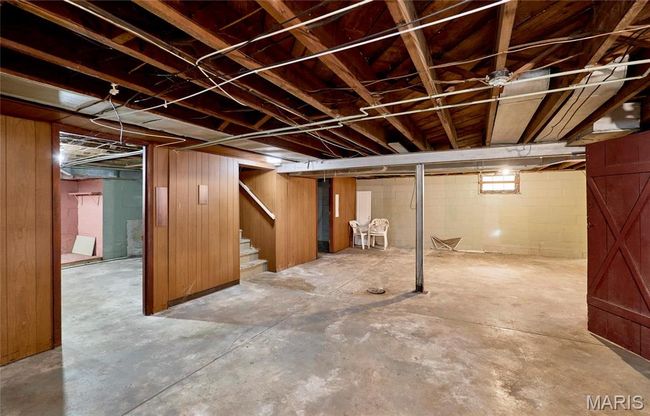 Basement featuring wood walls | Image 12
