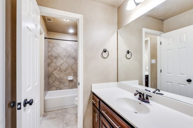 Full bath with visible vents, washtub / shower combination, toilet, vanity, and tile patterned flooring | Image 30