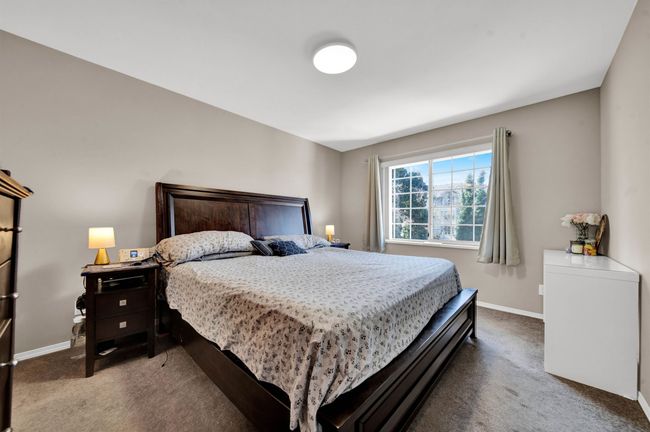 Bedroom with carpet flooring and baseboards | Image 12
