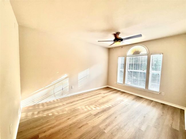 Spare room with wood finished floors and ceiling fan | Image 6