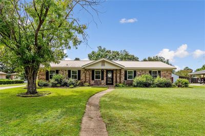 Single story home featuring a front yard and a carport | Image 1