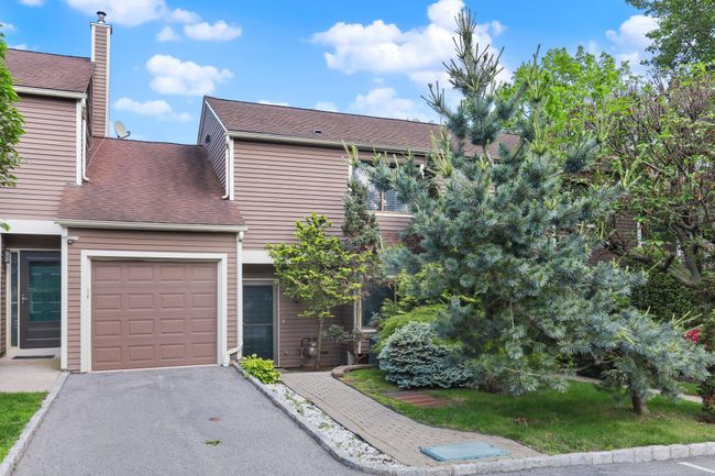 View of front of house featuring a garage, driveway, and roof with shingles | Image 36