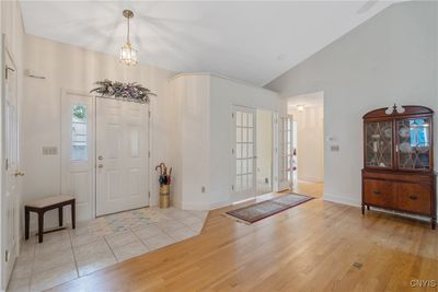 From the front door, we enter the foyer, magnified by the cathedral ceiling. Before we check out the living room/great room, let's check out the office. You can also see the hallway here leading to the bedrooms and bath. A very handy coat closet is located to your right as you walk in. | Image 3