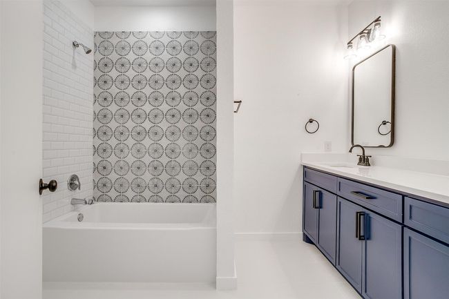 Full bathroom with tile patterned floors, vanity, and shower / bathing tub combination | Image 28