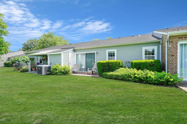 Rear view of property featuring a patio and a lawn | Image 17