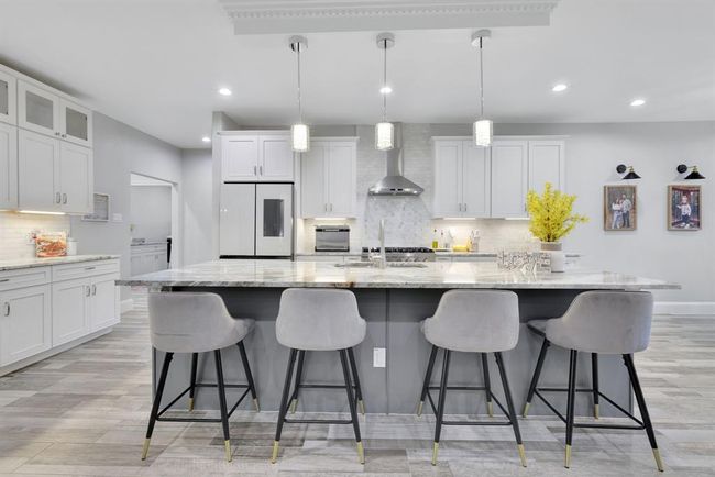 A striking view of the spacious island, designed to anchor the kitchen with both beauty and purpose. | Image 16