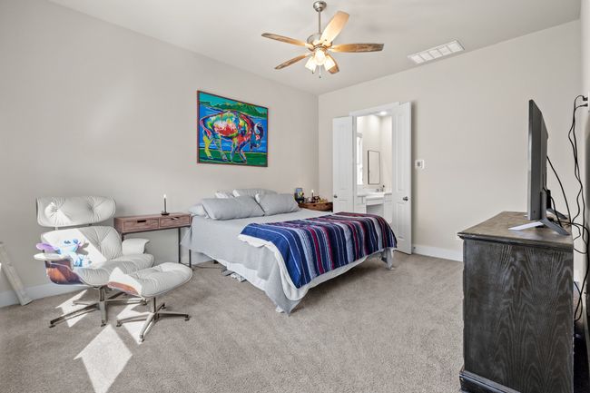 Bedroom with visible vents, baseboards, ceiling fan, and carpet flooring | Image 12